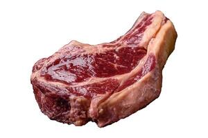 Fresh, raw beef steak with salt, spices and herbs photo