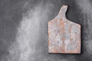 Empty wooden cutting board. Kitchen utensils photo