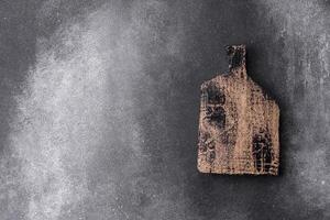 Empty wooden cutting board. Kitchen utensils photo