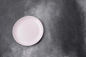 Empty ceramic plate on a dark textured background photo