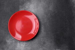 Empty ceramic plate on a dark textured background photo