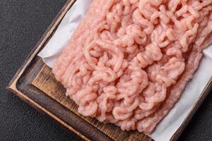 Fresh raw chicken mince with salt and spices photo