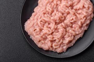 Fresh raw chicken mince with salt and spices photo