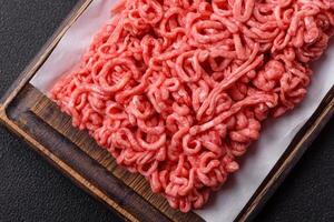 Fresh raw ground beef with salt and spices photo