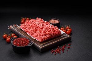 Fresh raw ground beef with salt and spices photo