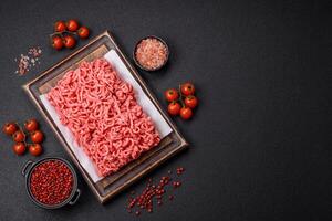Fresh raw ground beef with salt and spices photo