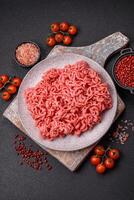 Fresh raw ground beef with salt and spices photo
