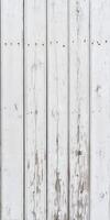 Weathered wood planks with white paint showing texture and character photo