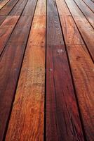 Wooden decking planks arranged in a herringbone pattern on a sunny day photo