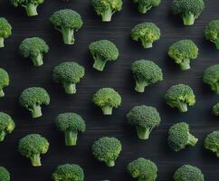 Fresh green broccoli arranged neatly on a dark wooden surface photo