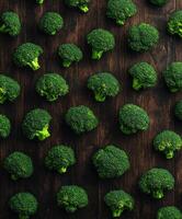 Fresh broccoli arranged on a wooden surface in a neat pattern photo