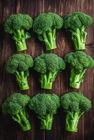 Fresh broccoli arranged on a wooden surface in a neat pattern photo