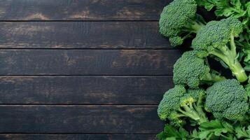 Fresh broccoli arranged on a wooden surface in natural light photo