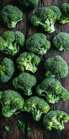 Fresh broccoli clusters on a wooden surface in natural lighting photo