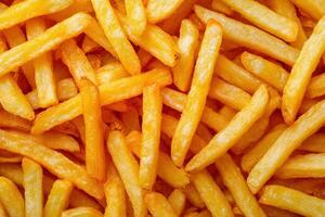Crispy golden French fries piled together in a delicious heap photo