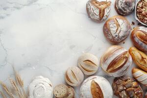 Freshly baked artisanal bread varieties on a marble surface photo