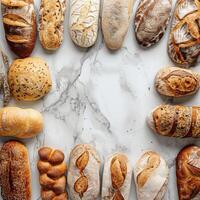 Freshly baked assortment of artisan bread on marble surface photo