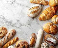 Freshly baked artisanal bread assortment on a marble countertop photo