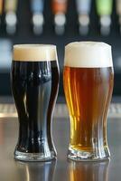Two glasses of dark and light beer on a bar counter photo