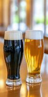 Two glasses of dark and light beer on a wooden bar counter photo