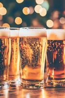 Beer mugs filled with foam on wooden table at a cozy bar photo