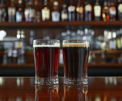 Two glasses of dark and light beer on a bar counter photo