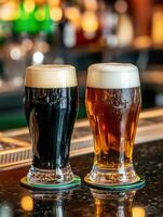 Two glasses of dark and light beer on the bar counter in a pub photo