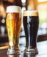 Two glasses of dark and light beer on a bar counter at sunset photo