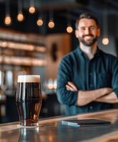 Two glasses of dark and light beer on a bar counter at a brewery photo
