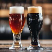 Two glasses of dark and light beer on a bar counter photo