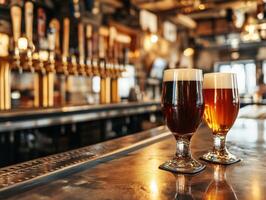 Two glasses of dark and light beer on a bar counter in a pub photo