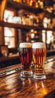 Two glasses of dark and light beer on a wooden bar counter photo