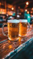 Beer mugs filled with foam on a wooden table in a lively bar photo