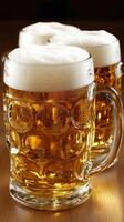 Beer mugs with frothy foam on a rustic wooden table in a bar photo