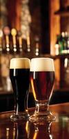 Two glasses of dark and light beer on a wooden bar counter photo