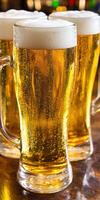 Beer mugs filled with golden brew and foam on a wooden bar table photo