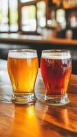 Two glasses of light and dark beer on a wooden bar counter photo
