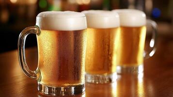Three frothy beer mugs on a bar table during an evening gathering photo