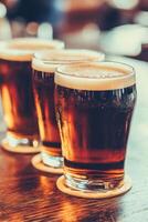 Beer mugs with foam on a wooden bar table during a festive evening photo