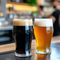 Two glasses of dark and light beer on a bar counter photo