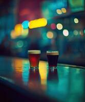 Dark and light beer glasses on a bar counter in a dimly lit pub photo
