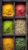 Assorted Indian spices arranged in a wooden spice box photo