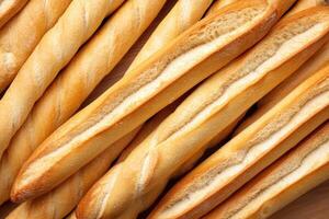 Freshly baked baguettes arranged on a wooden surface photo