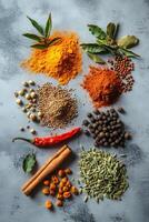Colorful array of Indian spices on a gray background photo