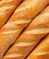 Freshly baked baguettes arranged in a warm, golden pattern photo