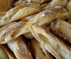 Freshly baked baguettes arranged on a wooden surface photo