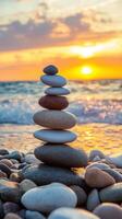 Stacked zen stones on a beach at sunset photo