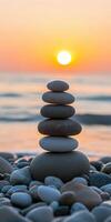 Balanced zen stones at sunset by the tranquil seaside photo