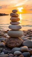 Stacked zen stones at sunset near a tranquil beach photo