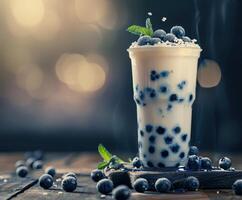 Boba milk tea with fresh blueberries at a cozy cafe setting photo